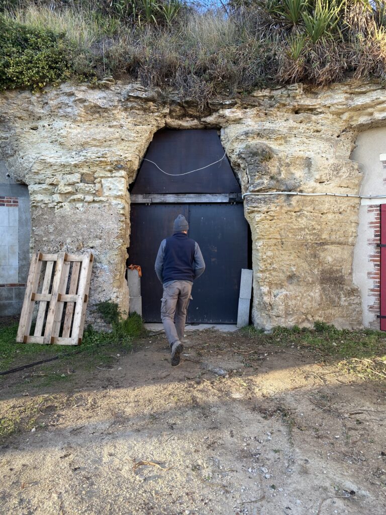 Alexandre Giquel, the young Vouvray winemaker, walking into his troglodyte cellar, where natural wine magic happens. 🍷